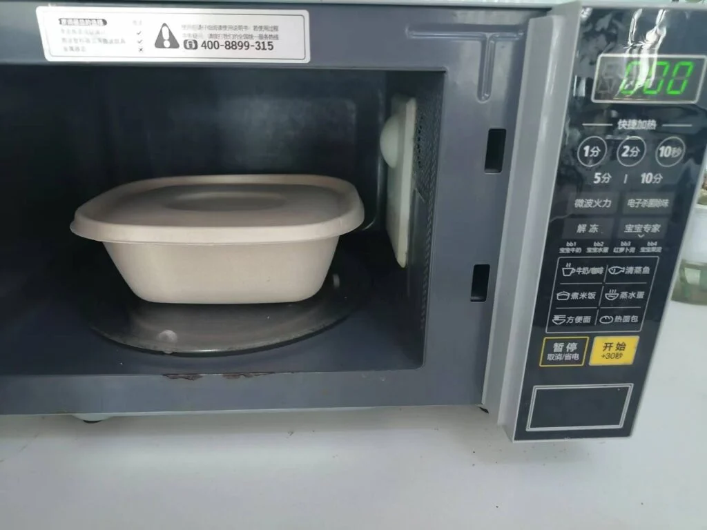 電子レンジ対応のバガス容器の画像。この容器は、サトウキビ加工から生まれる天然の副産物であるバガスから作られており、色は茶色です。頑丈なリブデザインで、様々なサイズがあります。電子レンジでの使用も安全なので、食品の保存や持ち運びに便利で環境に優しい選択肢です。バガス容器は生分解性があり、使用後は簡単に堆肥化できます。