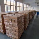 Rows of neatly organized, finished products stored on shelves in a clean, well-lit warehouse, ready for dispatch.