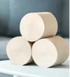Unbleached bamboo toilet paper rolls arranged on a wooden surface, showcasing their natural brown color and eco-friendly, sustainable design.